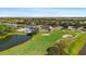 Aerial view of community clubhouse with pool and golf course at 10118 Cleghorn Dr, San Antonio, FL 33576