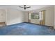 Spacious living room with blue carpet and ceiling fan at 19 Ventura Dr, Dunedin, FL 34698