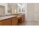 Double vanity bathroom with granite countertops and large shower at 2429 Nottingham Greens Dr # 118, Sun City Center, FL 33573
