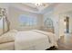 Spacious primary bedroom with large window and en-suite bathroom at 2429 Nottingham Greens Dr # 118, Sun City Center, FL 33573