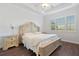 Main bedroom with large bed and hardwood floors at 2429 Nottingham Greens Dr # 118, Sun City Center, FL 33573