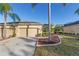 Two-car garage home with walkway and landscaping at 2429 Nottingham Greens Dr # 118, Sun City Center, FL 33573