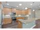 Kitchen with island, granite counters, and stainless steel appliances at 2429 Nottingham Greens Dr # 118, Sun City Center, FL 33573