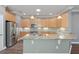 Spacious kitchen with light wood cabinets and granite countertops at 2429 Nottingham Greens Dr # 118, Sun City Center, FL 33573
