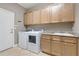 Convenient laundry room with ample cabinet space at 2429 Nottingham Greens Dr # 118, Sun City Center, FL 33573