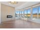Bright sunroom with lake view and electric fireplace at 2429 Nottingham Greens Dr # 118, Sun City Center, FL 33573