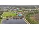 Aerial view of clubhouse, community pool, tennis courts, and lake at 4808 111Th E Ter, Parrish, FL 34219