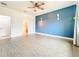 Primary bedroom with a blue accent wall, and a partial view of the en-suite bathroom at 4808 111Th E Ter, Parrish, FL 34219
