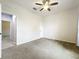 Bright bedroom featuring carpeted floor, a ceiling fan, and an adjoining bathroom at 4808 111Th E Ter, Parrish, FL 34219