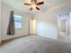 Bedroom featuring neutral walls, carpeted floors, a ceiling fan and a view of the hallway at 4808 111Th E Ter, Parrish, FL 34219