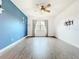 Bedroom featuring wood-look floors, blue accent wall, window and a ceiling fan at 4808 111Th E Ter, Parrish, FL 34219