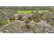 Aerial view of the stately clubhouse surrounded by lush landscaping, circular driveway, and ample parking at 4808 111Th E Ter, Parrish, FL 34219
