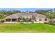Elegant clubhouse featuring a manicured lawn, circular garden, covered patio, and well-maintained landscaping at 4808 111Th E Ter, Parrish, FL 34219