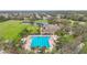 Aerial shot showcasing the pool, tennis courts, clubhouse, and surrounding community, highlighting an active lifestyle at 4808 111Th E Ter, Parrish, FL 34219