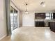 Dining area features tile floors, modern chandelier, and a sliding glass door leading to the patio at 4808 111Th E Ter, Parrish, FL 34219