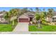 Stunning single-story home boasting an attached two-car garage, and mature tropical landscaping at 4808 111Th E Ter, Parrish, FL 34219