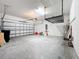 Bright two-car garage featuring an automatic door, overhead rack, and water heater at 4808 111Th E Ter, Parrish, FL 34219