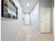 Long hallway with tile floors, neutral paint, and a decorative mirror on the left wall at 4808 111Th E Ter, Parrish, FL 34219