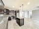 Stylish kitchen featuring an island, granite countertops, stainless steel appliances, and tiled floors at 4808 111Th E Ter, Parrish, FL 34219