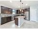 Modern kitchen featuring granite countertops, stainless steel appliances, and dark wood cabinets at 4808 111Th E Ter, Parrish, FL 34219