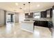 Modern kitchen featuring dark cabinetry, granite countertops, and stainless steel appliances at 4808 111Th E Ter, Parrish, FL 34219