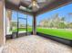 Screened in porch with brick-paved floors, ceiling fan, and an open view of the fenced backyard at 4808 111Th E Ter, Parrish, FL 34219