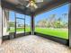 Screened lanai with brick-paved floors, ceiling fan, and expansive view of the lush backyard at 4808 111Th E Ter, Parrish, FL 34219