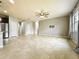 Bright and airy living room with neutral paint, tile flooring and a modern ceiling fan at 4808 111Th E Ter, Parrish, FL 34219