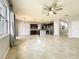 Open-concept living room and kitchen with a central island, stainless steel appliances, and tile flooring at 4808 111Th E Ter, Parrish, FL 34219