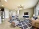 Bright and airy living room with tile floors, ceiling fan, modern furniture, and a large area rug at 4808 111Th E Ter, Parrish, FL 34219