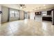 Open living room with tile floors, natural light, ceiling fan and an open concept to the kitchen at 4808 111Th E Ter, Parrish, FL 34219