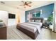 Spacious main bedroom featuring modern decor, a ceiling fan, and an en suite bathroom at 4808 111Th E Ter, Parrish, FL 34219