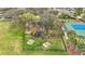 Elevated view of playground with colorful play structures, picnic tables, and benches in grassy, fenced area at 4808 111Th E Ter, Parrish, FL 34219