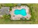 Aerial view of a kidney-shaped pool surrounded by a brick patio and lush landscaping at 4808 111Th E Ter, Parrish, FL 34219