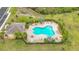 Aerial view of kidney-shaped community pool with deck and well-manicured landscaping at 4808 111Th E Ter, Parrish, FL 34219