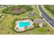 Aerial view of community pool area with lounge chairs and lush landscaping at 4808 111Th E Ter, Parrish, FL 34219