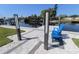 Waterfront backyard featuring a canal view, dock, and blue Adirondack chairs at 817 Blue Heron Blvd, Ruskin, FL 33570