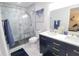 Elegant bathroom featuring a double vanity, stylish mirrors, and glass-enclosed shower with modern tile at 817 Blue Heron Blvd, Ruskin, FL 33570