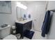 Well-lit bathroom offering double sinks, toilet, cabinet storage, and a towel rack at 817 Blue Heron Blvd, Ruskin, FL 33570