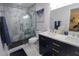 Elegant bathroom featuring a double vanity, stylish mirrors, and glass-enclosed shower with modern tile at 817 Blue Heron Blvd, Ruskin, FL 33570