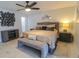 Comfortable bedroom featuring a ceiling fan, artwork, and a soft bench at 817 Blue Heron Blvd, Ruskin, FL 33570