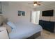 Bright bedroom featuring tiled flooring, ceiling fan, and dark wood dresser at 817 Blue Heron Blvd, Ruskin, FL 33570