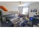 Well-lit bedroom with bunk beds, a desk area, and comfortable seating at 817 Blue Heron Blvd, Ruskin, FL 33570