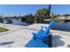 Inviting backyard with waterfront views and a dock, complete with comfortable Adirondack chairs at 817 Blue Heron Blvd, Ruskin, FL 33570