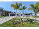 Charming exterior showcasing well-manicured landscaping and a unique architectural style at 817 Blue Heron Blvd, Ruskin, FL 33570