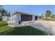 Charming home featuring a two-car garage, well-maintained landscaping, and a spacious driveway at 817 Blue Heron Blvd, Ruskin, FL 33570