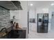 Modern kitchen with stainless steel appliances, white cabinetry, and a stylish backsplash, a culinary haven at 817 Blue Heron Blvd, Ruskin, FL 33570