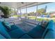 Enclosed lanai with comfortable seating, water views, and outdoor dining, perfect for relaxing and entertaining at 817 Blue Heron Blvd, Ruskin, FL 33570