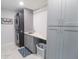 Well-organized laundry room with modern washer and dryer, ample storage, and stylish finishes at 817 Blue Heron Blvd, Ruskin, FL 33570