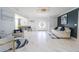 Bright living room with white marble floors and neutral decor is designed for modern comfort and style at 817 Blue Heron Blvd, Ruskin, FL 33570